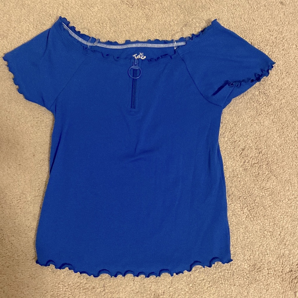 A blue ruffle top with zipper